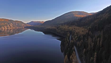 aerial drone shot in montana on a lake with a boat in the fall or autumn