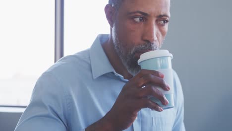 businessman drinking coffee in modern office
