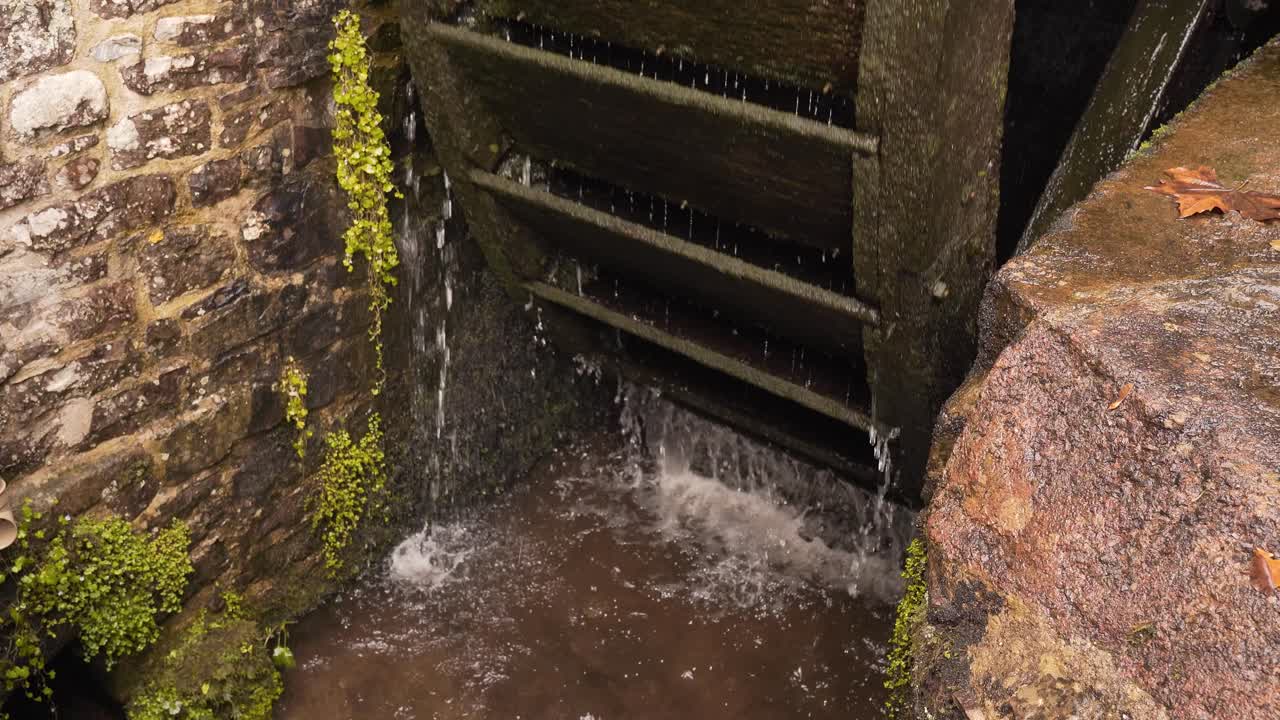 Close up on a section of a wooden water wheel from a water mill