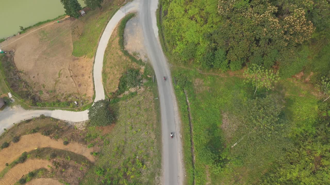 Aerial View of Motorcycles Traveling on Narrow Mountain Roads in Ha Giang Province