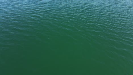 seamless aerial drone view on turquoise lake water ripples close up. aerial view over sea or ocean with beautiful waves pattern landscapes view of endless aquamarine water in summer day.