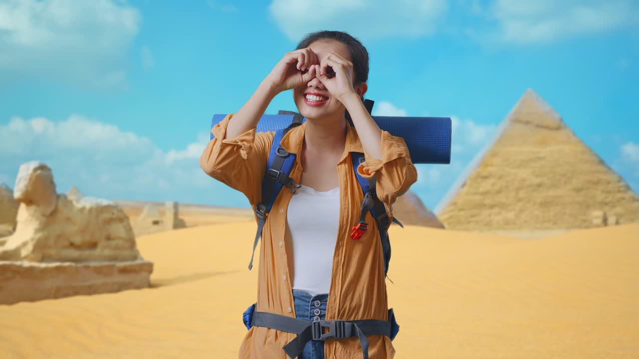 Asian Female Hiker With Mountaineering Backpack Making Binoculars Gesture Looking At Something Then Saying Wow While Traveling In Pyramid Of Giza