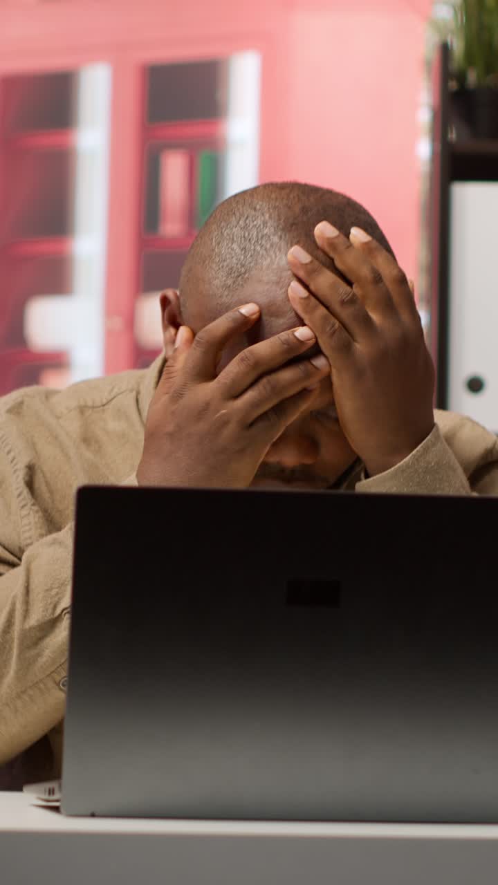 African American Man Reacts with Shock and Frustration to Bad News on Laptop