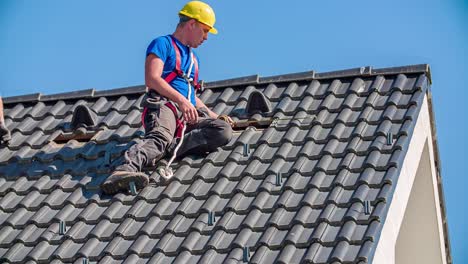 Young-and-professional-roofer-measures-roof-tiles-with-meter