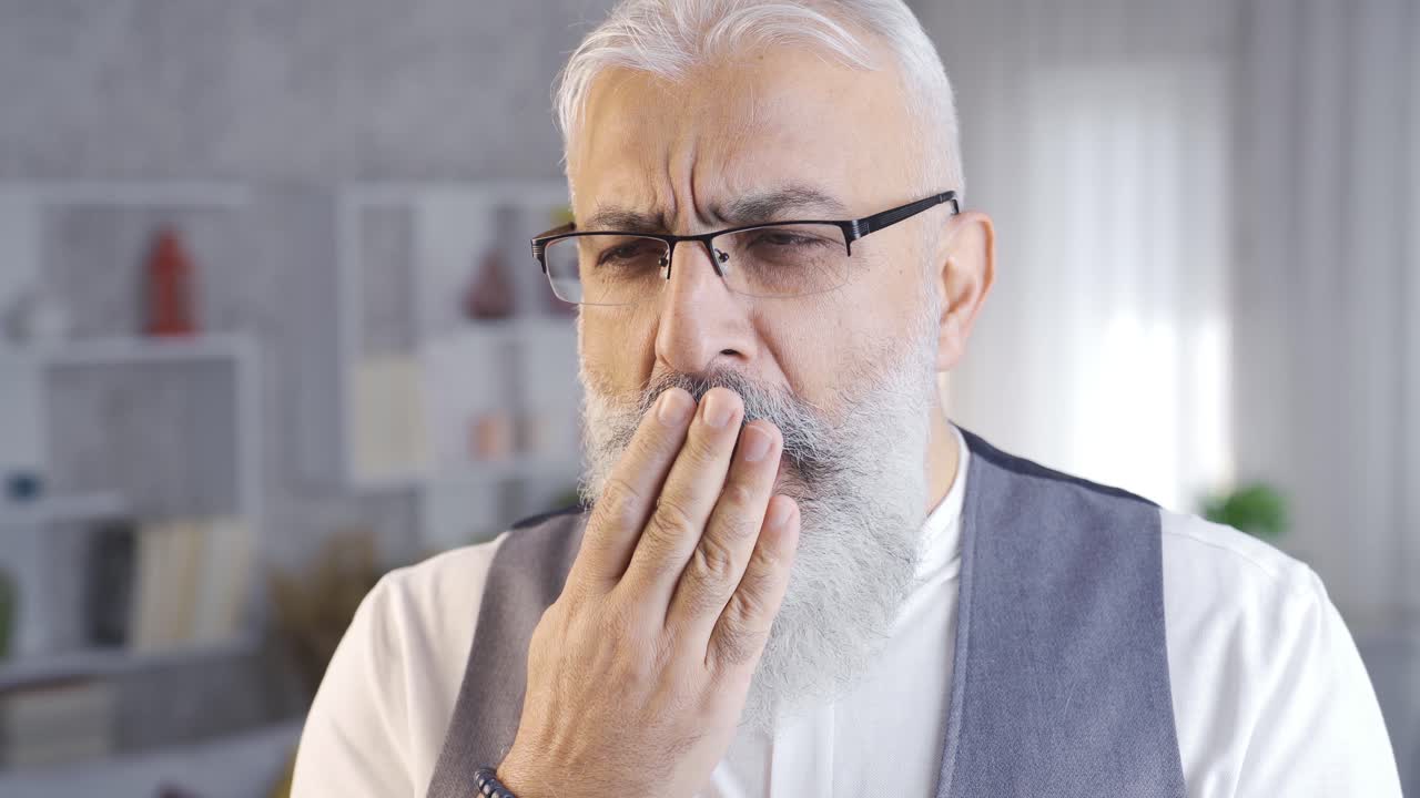 Sleepy man yawns and eyes tired.