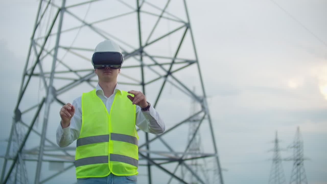 The male engineer manages the transmission of alternative energy from solar panels and wind farms to the consumers of the metropolis. The concept of the modern city.