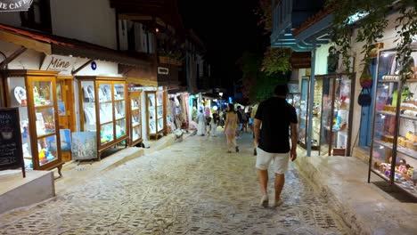 explore the lively streets of kaş's old town at night, with bustling local shops and a warm, inviting atmosphere
