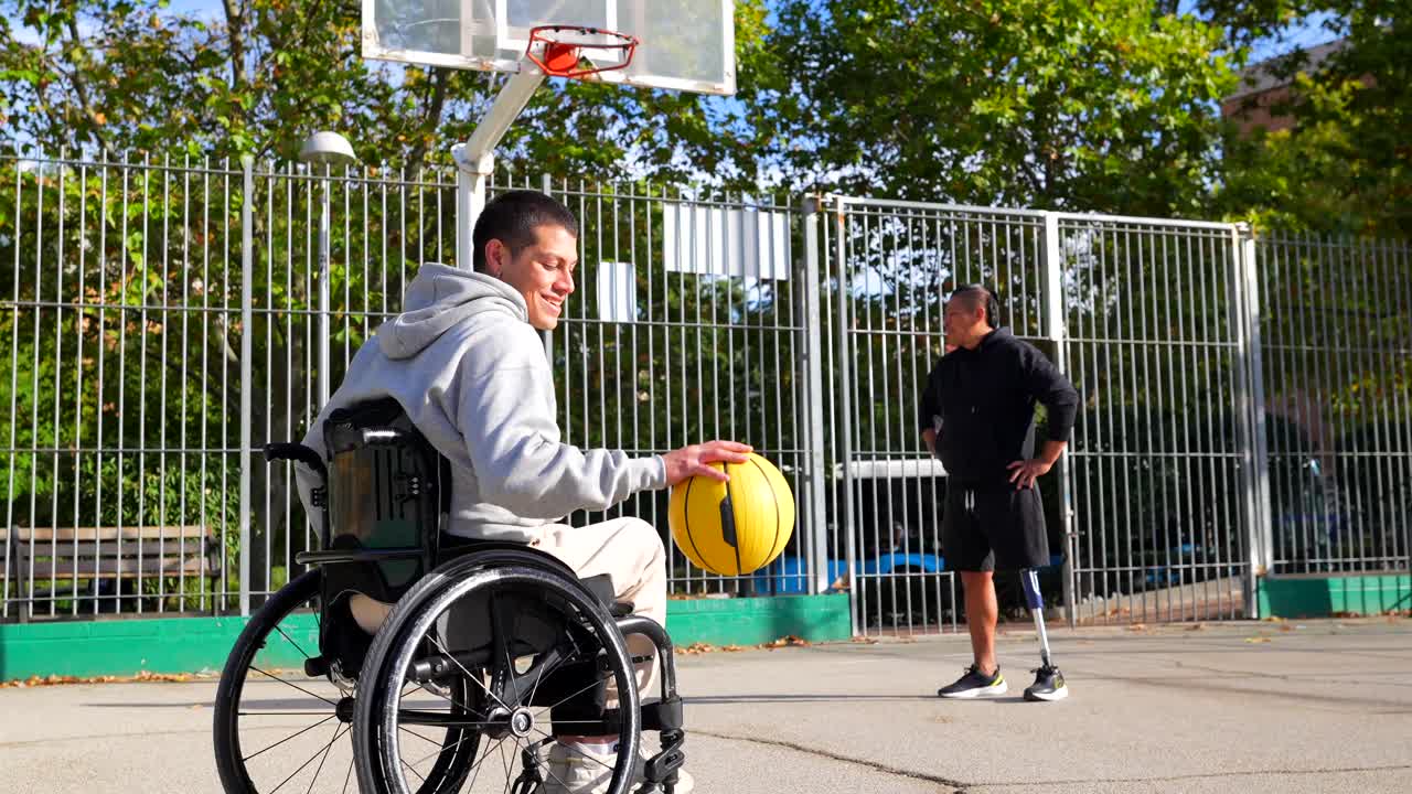 Men with disabilities playing basketball on an outdoor court