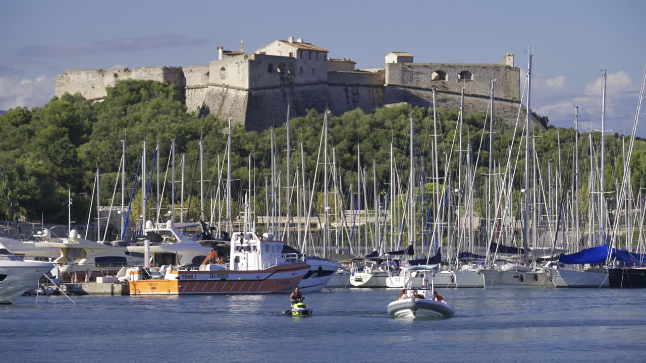 Antibes, France - June 7, 2025: Multiple white boats docked in the Port Vauban with the Fort Carre on the background in daylight