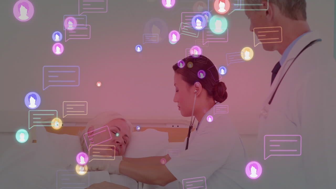 Female doctor with stethoscope examining chest of patient in hospital bed with chat icons floating