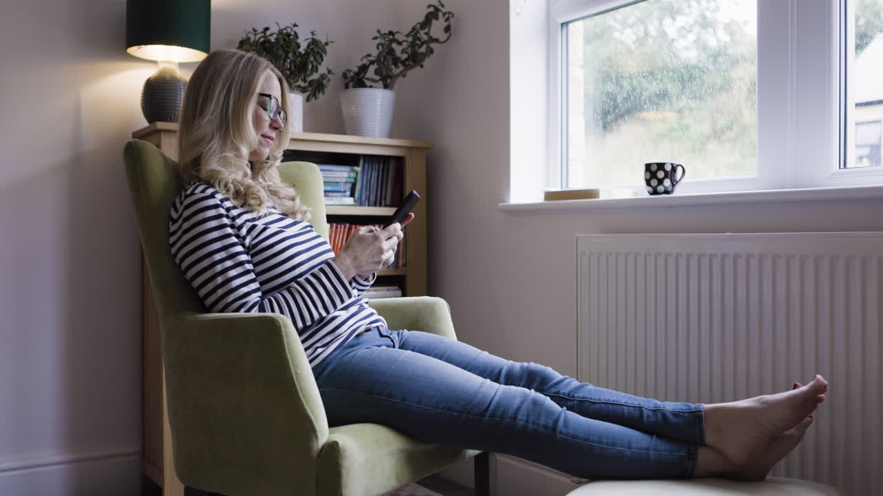 Woman relaxing in armchair at home