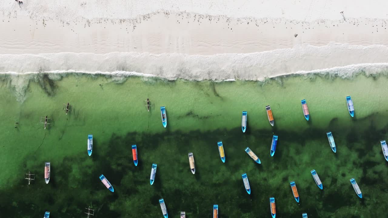 Matemwe beach, High angle aerial top shot static of boats gathered on shallow reef water near Zanzibar white sand beach coast, backdrop background