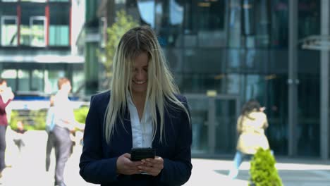 happy, smiling business woman using her smartphone on work break