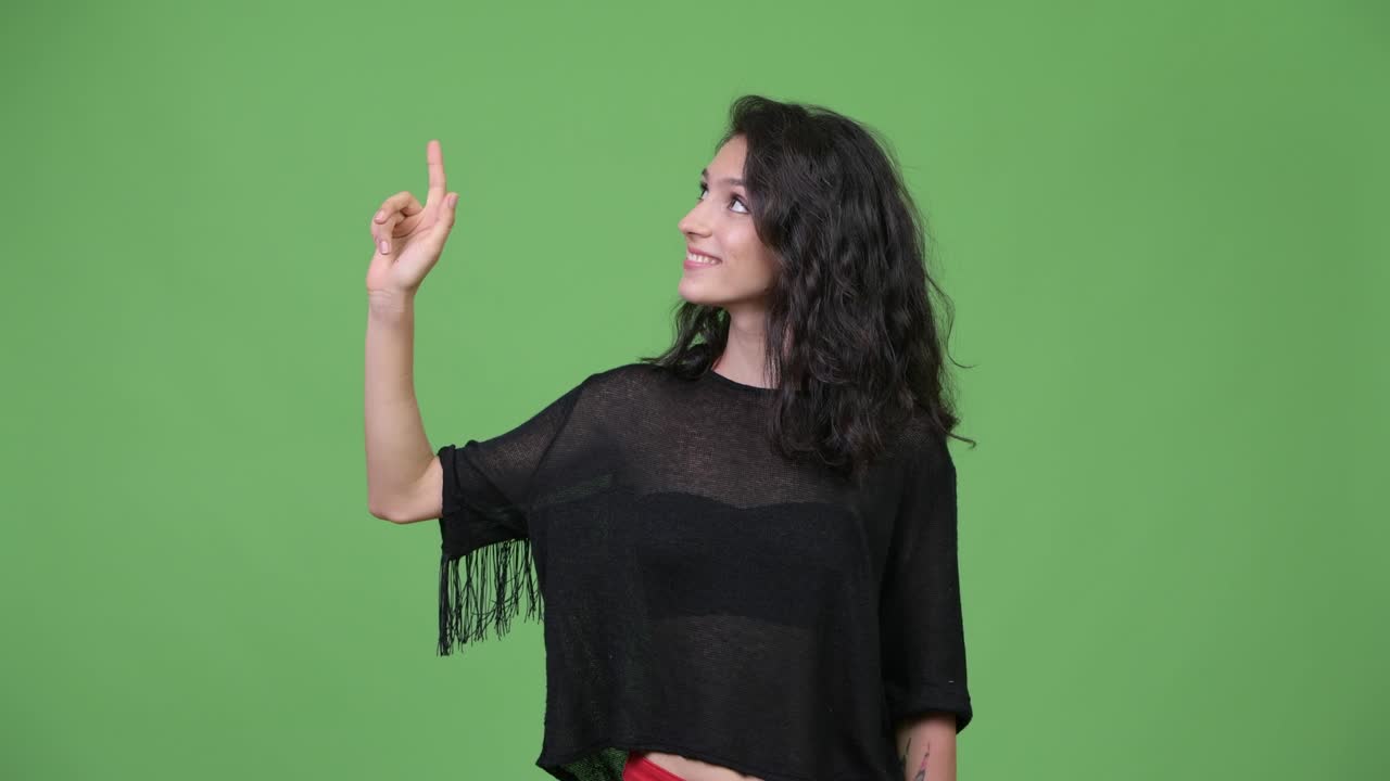 Happy young beautiful woman thinking and pointing up
