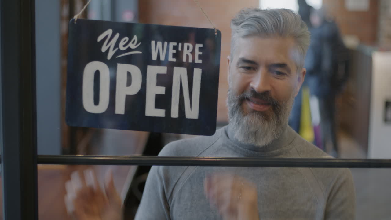 Store Owner Hanging Open/Closed Sign