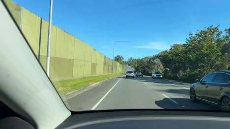 cars navigating a sunny motorway exit ramp