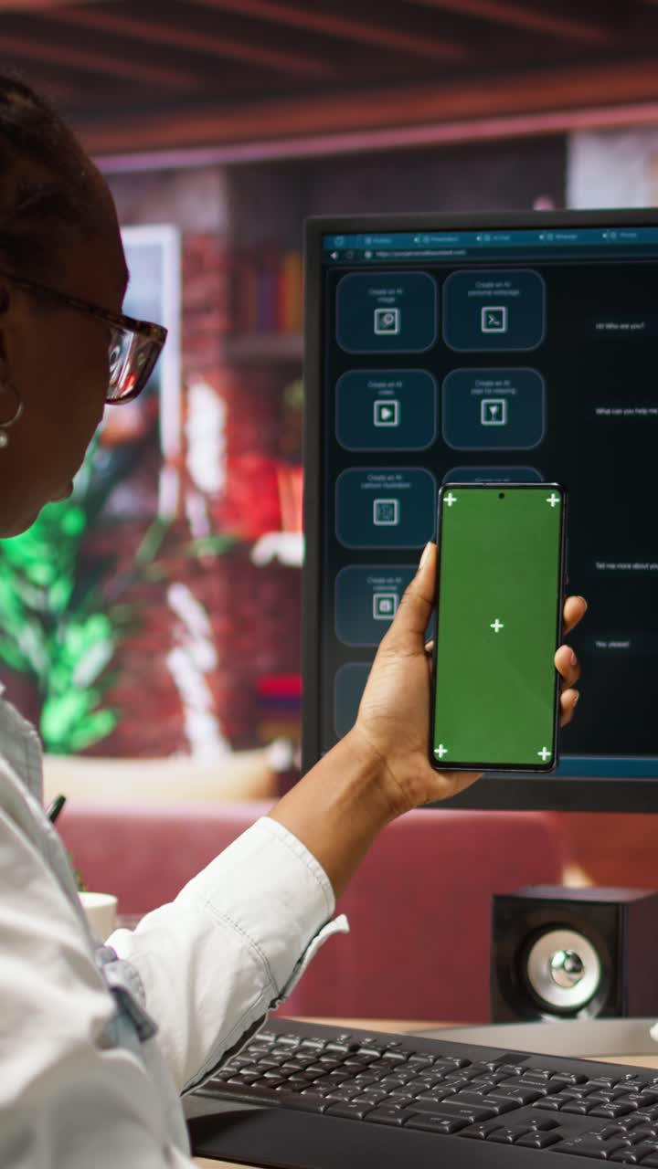 Vertical video Woman seated at desk using AI LLM chatbot software and green screen phone