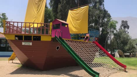 Video-of-a-small-wooden-boat-in-a-children's-playground-area