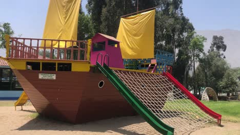 video of a small wooden boat in a children's playground area