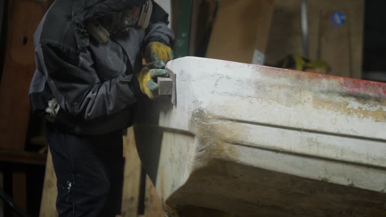 Sanding transom of small fiberglass fishing boat transom
