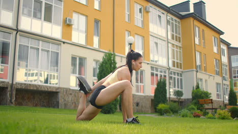 to complete the exercise of warm-up and warm-up muscles before training. a woman in the park in headphones performs a hitch with stretching after a successful fitness workout. restoring strength