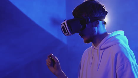 young man using a vr headset on a colorful neon light background 1