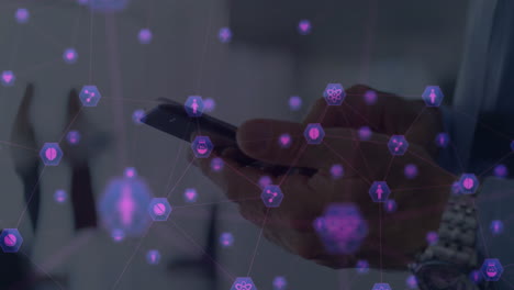 animation of network of digital icons against mid section of man using smartphone at office