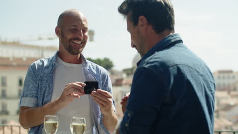 Handheld-shot-of-gay-proposing-to-boyfriend-during-date-on-roof