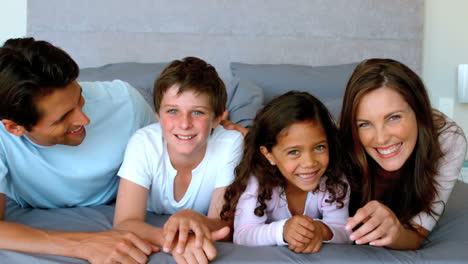 family lying on a bed