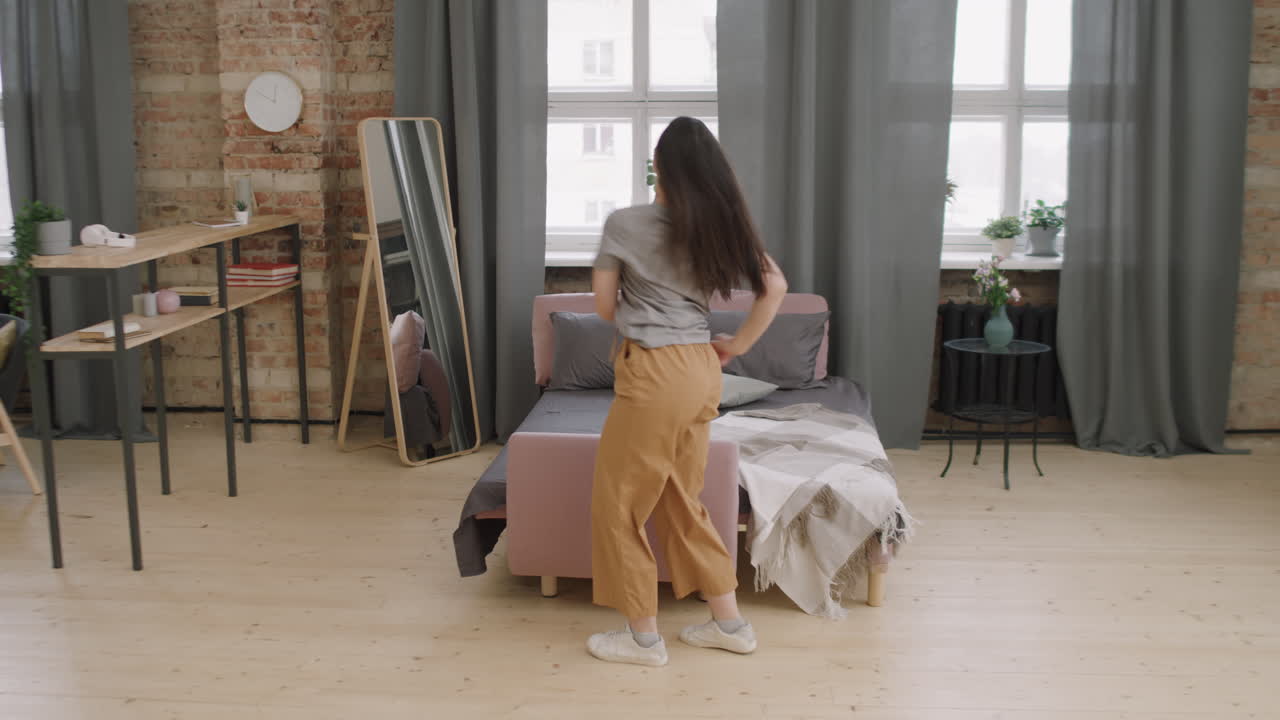 Energetic Young Woman Dancing at Home