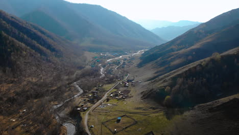 Aerial View of a Rural Village in a Mountain Valley with a River
