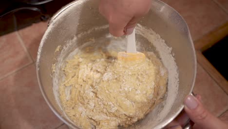 mixing flour and beaten eggs for the thick cake batter