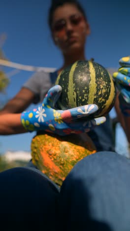 woman gardening with pumpkins