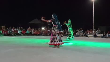 women performing kalbeliya dance for a group of tourists. it is an integral part of kalbelia culture. live tribal folk music. the thar desert.