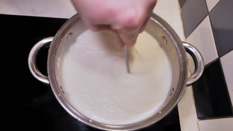 slow motion stirring of semolina mixture over stove, nostalgic morning mood, 4k
