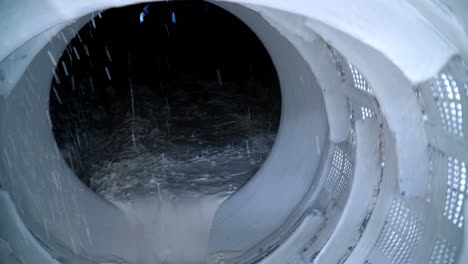 filtering white kaolin in the rotating mechanism at the factory. modern plant for processing industrial minerals. close up.
