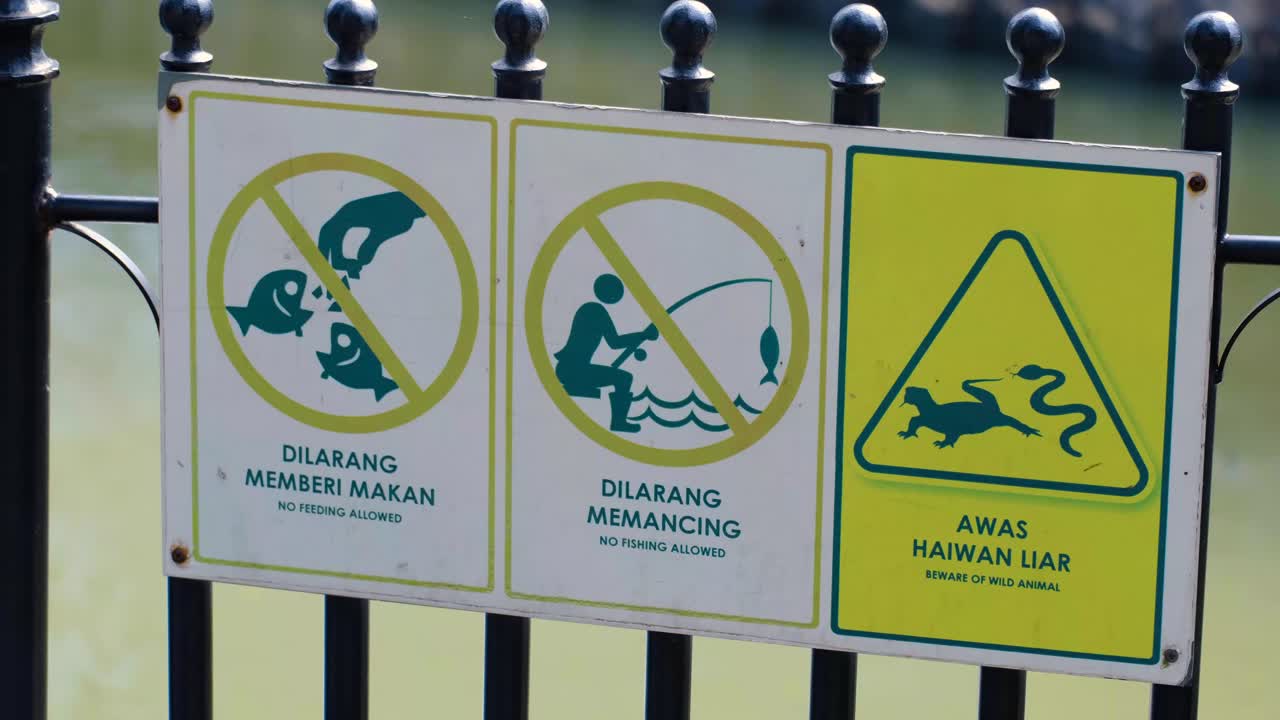 Warning Signs at a Park or Pond: No Feeding, No Fishing, Beware of Wild Animals
