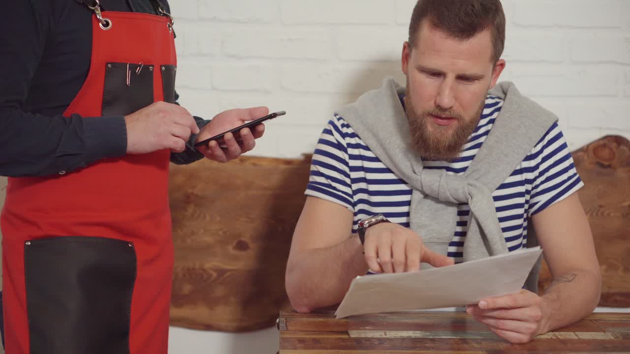 Waiter taking an order from a customer in a restaurant