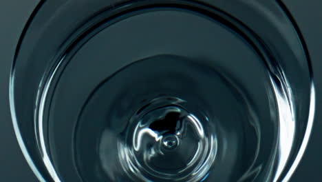 closeup water droplet falling smooth surface top view. pure mineral liquid wave