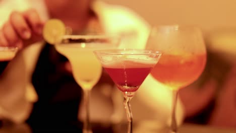 bartender garnishing cocktails with lime slices