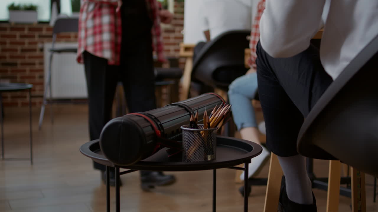 Colorful pencils and artistic equipment on table in studio at art class