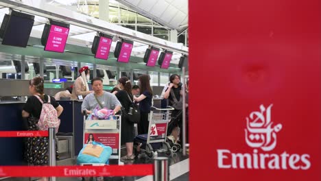 passengers queuing at emirates airline check-in counter