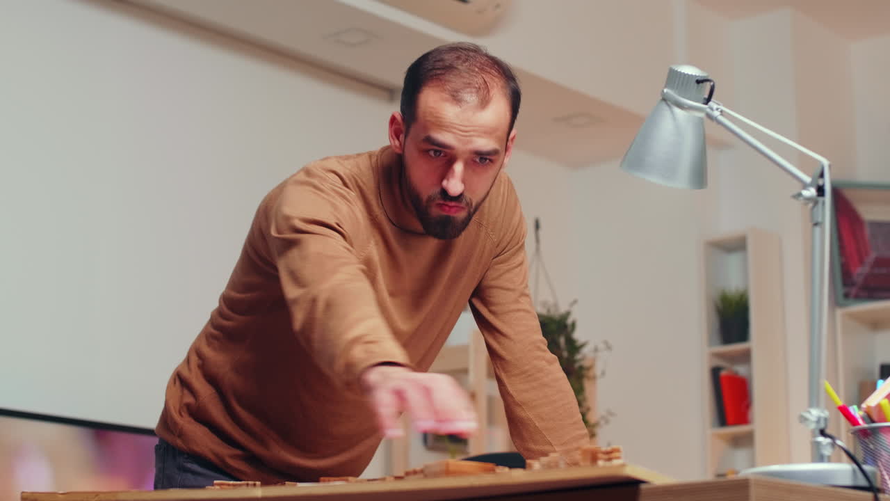 Professional male architect working on a city model