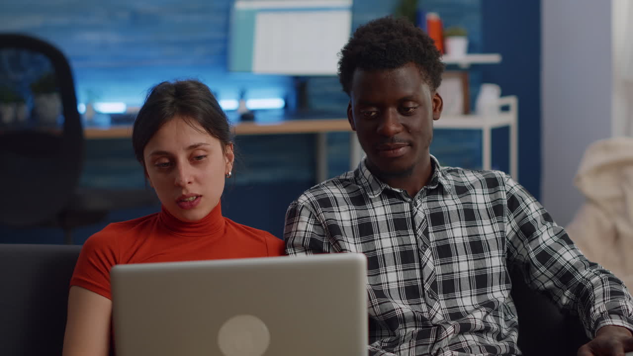 Young interracial couple chatting on video call conference