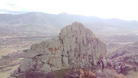 Climbers-climbing-a-rock-drone-shot