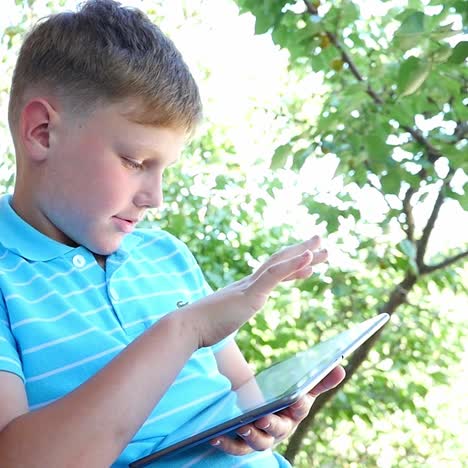 boy using a tablet outdoors
