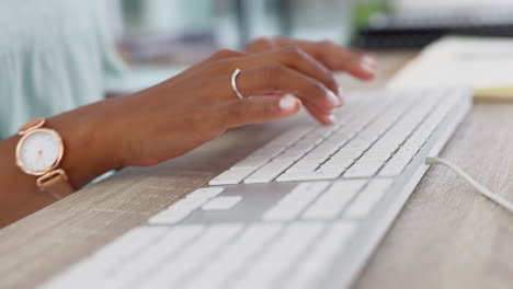 hands of a woman typing an email on a keyboard as