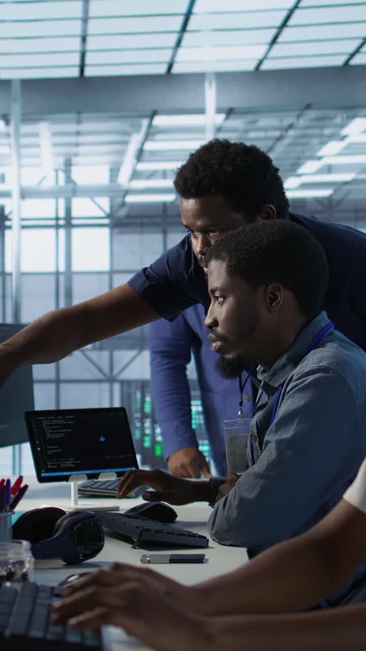 Vertical video Manager supervising server room workers