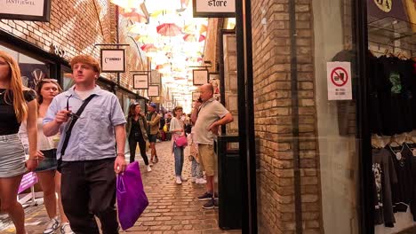 people walking through camden market, london