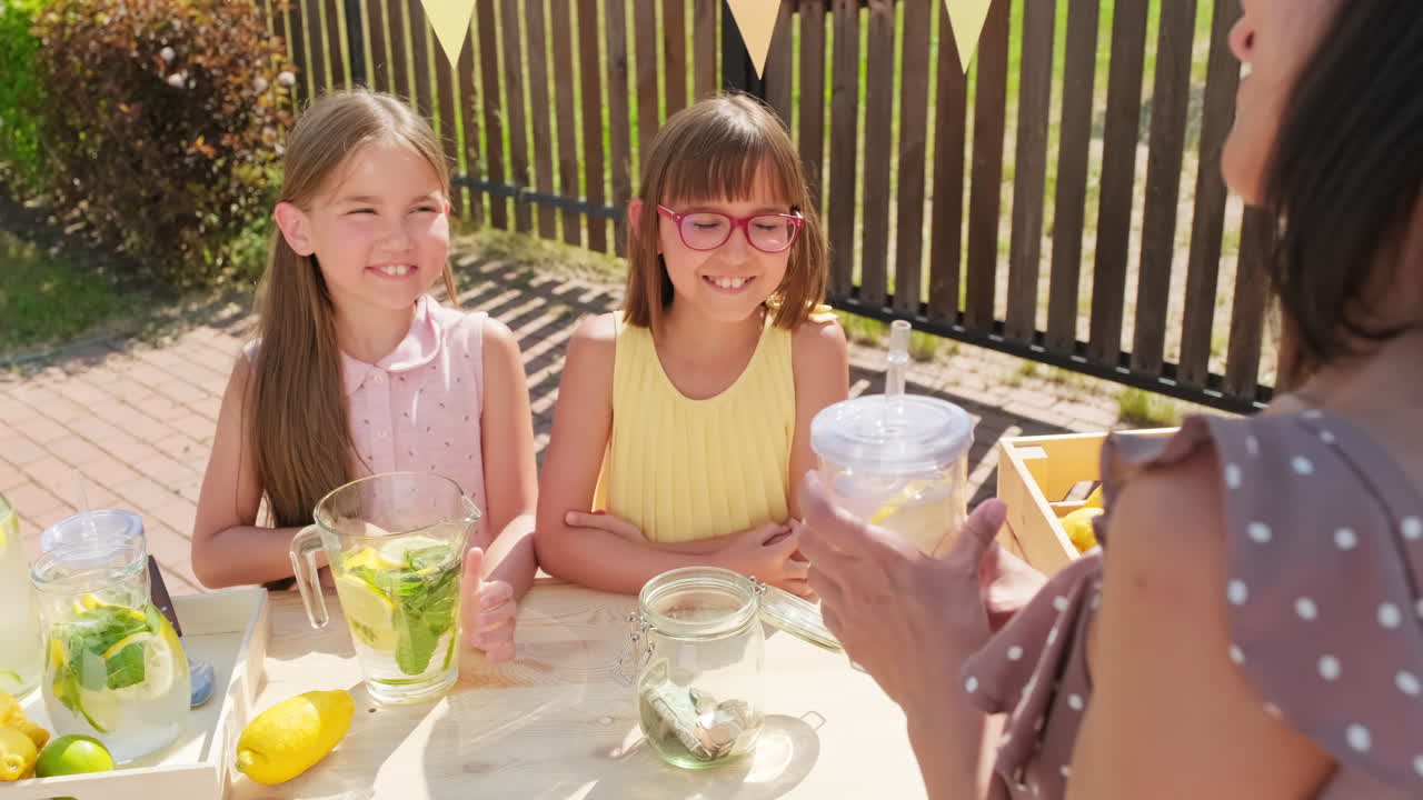 Woman Buying Lemonade From Childs Stand